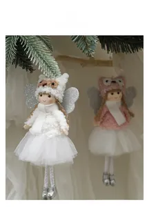 Close-up of plush angel doll with white mesh skirt and silver wings on Christmas tree