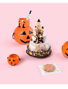 Close-up of Halloween castle cupcake stand with cookies and orange pumpkin buckets