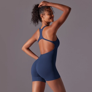 Detail showing the ribbed navy blue fabric and open back design of the yoga bodysuit