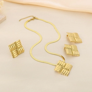 Detail of 18K gold stainless steel jewelry set featuring square woven texture motifs