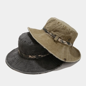 Detailed macro of washed cotton bucket hat with digital camo webbing and metal eyelets