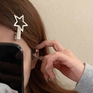 Silver Y2K metal star-shaped shark hair claw clip worn on hair for a stylish look