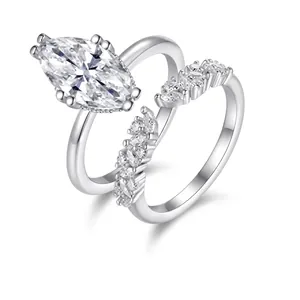 Close-up of S925 silver marquise moissanite ring set with curved diamond band
