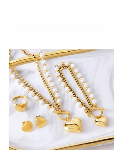 Titanium jewelry set with heart pendant necklace, ring and studs on marble tray