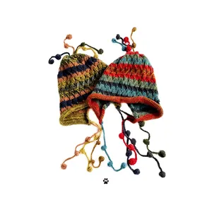 Colorful striped knit beanie with earflaps and tassels shown on a white background