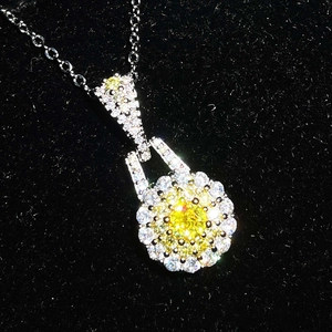 Detailed view of luxury silver necklace with a brilliant yellow round pendant and halo diamonds