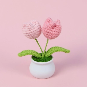 Handmade crochet double-headed pink tulip potted plant ornament on pink background