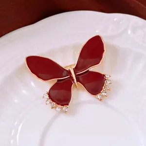 Vintage style butterfly brooch in deep red enamel with gold edges and crystal accents