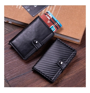 Detail view of leather and carbon fiber RFID blocking card holders with pop-up mechanism