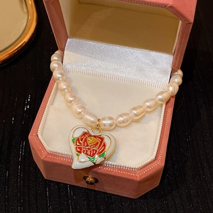 Detail showing baroque freshwater pearl necklace with rose heart pendant in gift box