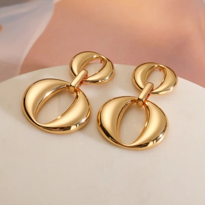 Elegant 18K gold plated double oval link earrings on a white stand with soft pink fabric