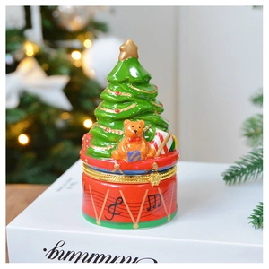 Detailed view of a Christmas tree jewelry box on a red musical drum base with enamel finish