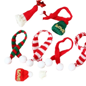 Detail showing mini red and green knitted Christmas hats and scarves with LOVE gold letters