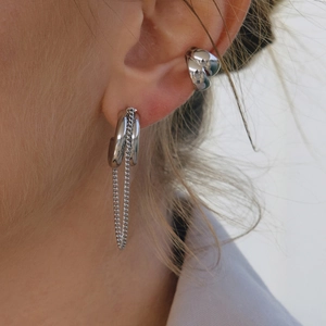 Silver stainless steel tassel hoop earring and ear cuff set shown on a model