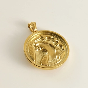Macro shot of gold stainless steel horse head embossed pendant with high-polished finish