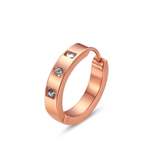 Macro detail of 18K rose gold plated hoop earrings with three sparkling inlaid crystals