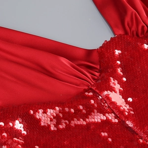 Macro detail of wine red evening dress featuring sequin embroidery and satin stitching