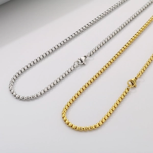 Detailed view of silver and gold stainless steel box chain necklaces with lobster clasps