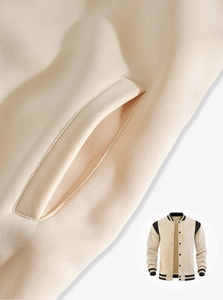 Detail of diagonal side pocket on varsity jacket showing premium stitching and fabric texture