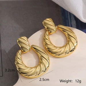Detail view of 18k gold plated geometric twisted hoop earrings with size and weight marks