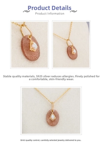 Macro shot of 925 silver gold-plated pendant with oval brown stone and teardrop opal