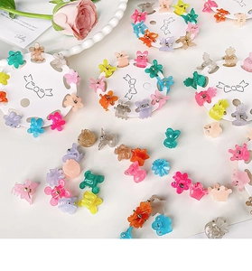 Detailed macro view of assorted mini colorful resin hair clips in various cute shapes
