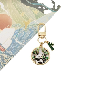 Cute panda and bamboo keychain in gold metal with black and white enamel finish
