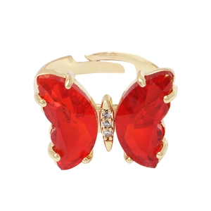 Elegant gold butterfly ring with red crystal wings and small diamonds on white background