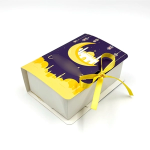 Detail view of purple Eid moon and star gift box with yellow ribbon and window