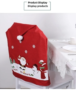 Detail of red Santa Claus chair cover with festive prints on a white dining chair