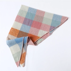 Detail of colorful plaid cashmere-like scarf showing texture and overlock stitched edges