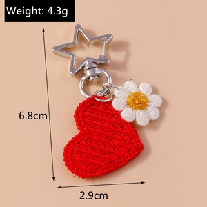 Detail view of knitted red heart keychain with dimensions 6.8cm and 4.3g weight