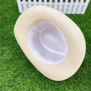 Detail of a beige woven straw sun hat showing internal 58cm size label and paper material