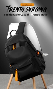 Detail of waterproof Oxford backpack showing vibrant orange zipper pulls and pocket layout