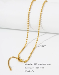 Detail of 2.5mm golden 316 stainless steel ball chain on a minimalist display