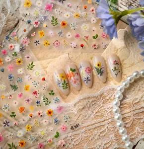 Detail of floral nail art stickers M-1381 with gold foil accents and pastel blooms