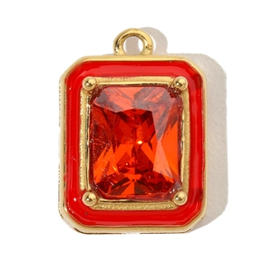 Macro shot of square gold titanium pendant with red enamel and large rectangular gemstone