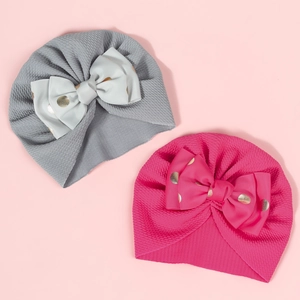 Newborn bubble fabric baby turbans in grey and rose pink with gold polka dot bows