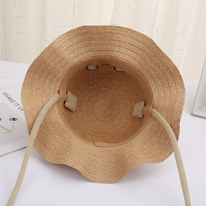 Detail showing inner sweatband and adjustable drawstring of straw sun hat for children