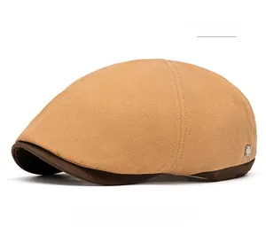 Detail view of khaki cotton newsboy cap with vintage brown brim and metal buckle accent