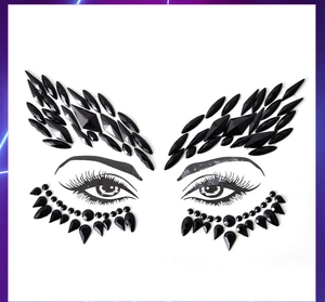 Detailed close-up of black wing-shaped acrylic face rhinestones and teardrop gem stickers