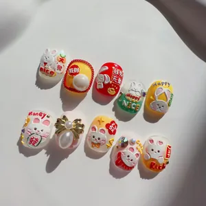 Close-up of 3D embossed rabbit nail stickers with pearls and bow accessories