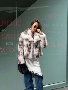 Detail of faux fur coat with brown spotted pattern and elegant wide lapel collar