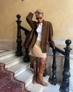 Classic dark brown suede blazer styled with a beige mini skirt and leather boots