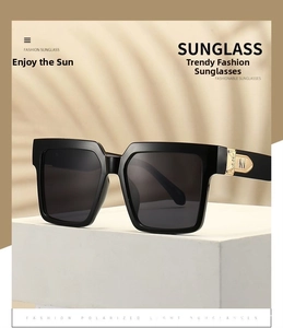 Detail of square sunglasses with golden M-shaped metal hinge on black temples