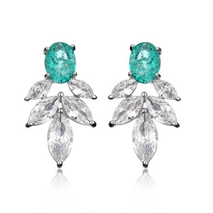 Macro shot of silver stud earrings with turquoise gems and white marquise zircons