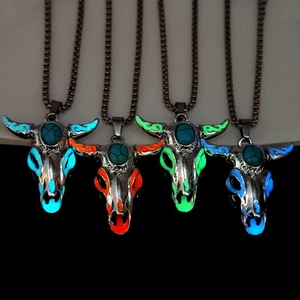 Detailed view of luminous bull skull pendants glowing in four vibrant neon colors