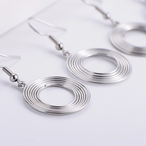 Silver concentric spiral coil hoop earrings in polished metal for a modern minimalist look