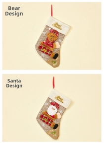 Detail of linen Christmas stockings with Santa, bear motifs and Merry Christmas embroidery