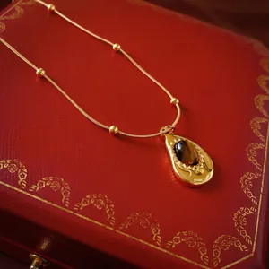 Collier luxueux en acier inoxydable doré avec pendentif goutte en œil de tigre